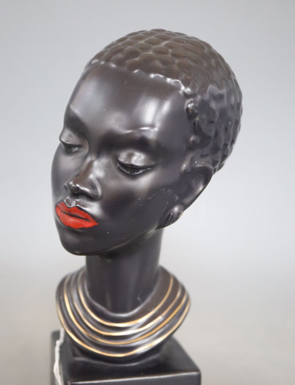 A 1960s ceramic bust of a tribal woman, signed, height 22cm